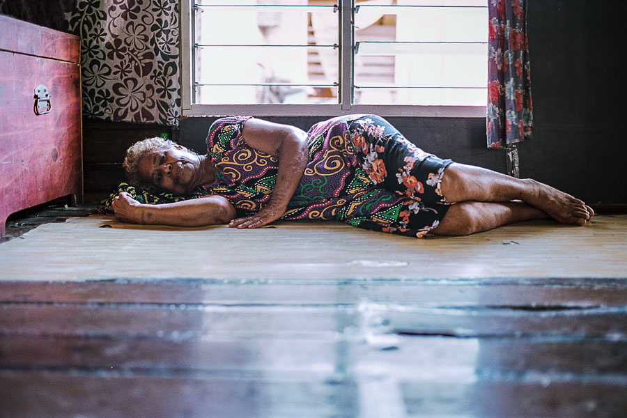 Une femme âgée fait la sieste dans sa maison sur pilotis dans le village Motu Hanuabada, en Papouasie-Nouvelle-Guinée - Christophe MOEC